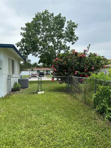 a view of a backyard with a swing and plants