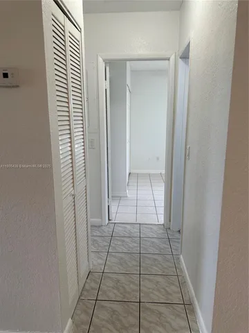 a view of an empty room and a bathroom