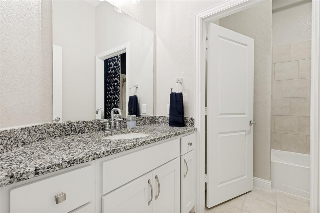 229 Savannah Lane Oak Point, TX 75068 - Photo 20 of 26 a bathroom with a granite countertop sink and a mirror