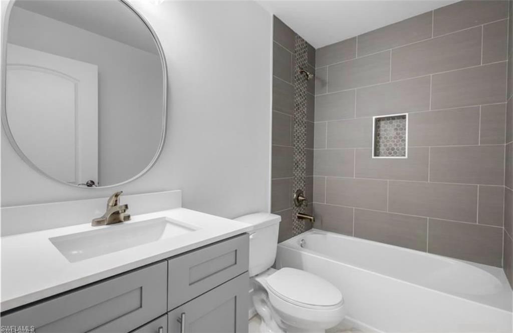 402 Grant Boulevard Lehigh Acres, FL 33974 - Photo 7 of 9 a bathroom with a sink a toilet and shower