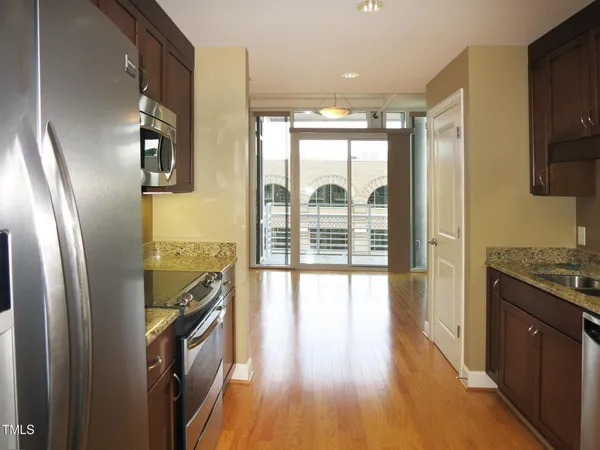 a view of a kitchen with a large window