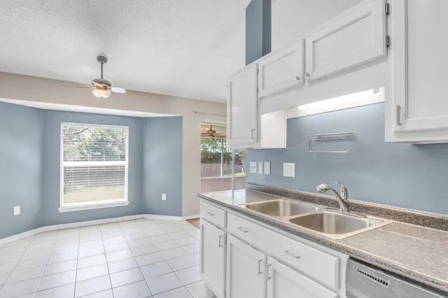 a kitchen with a sink cabinets and window