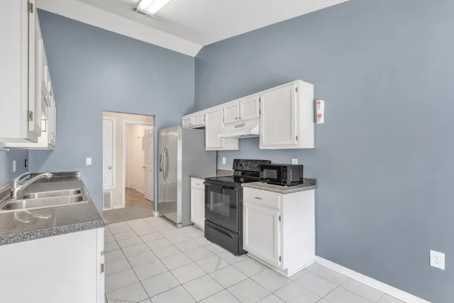 a kitchen with a stove a sink and a refrigerator