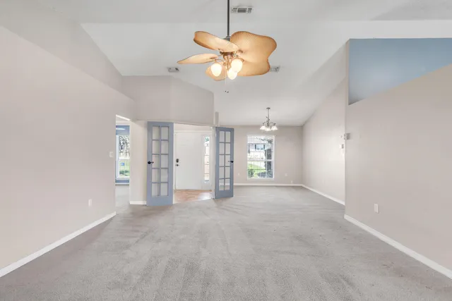 a view of a livingroom with a chandelier fan