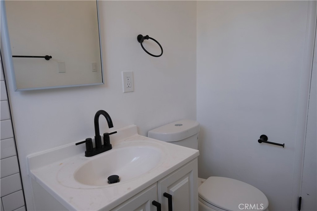 3180 Jane Street Riverside, CA 92506 - Photo 19 of 28 a bathroom with a sink a toilet and mirror