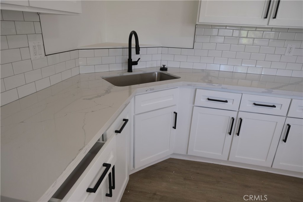 3180 Jane Street Riverside, CA 92506 - Photo 9 of 28 a kitchen with white cabinets and sink