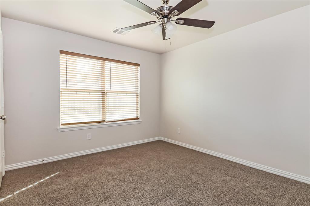 4712 Stokes Street Dallas, TX 75216 - Photo 13 of 16 an empty room with a window and a fan