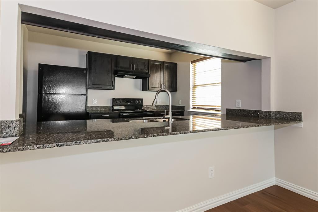4712 Stokes Street Dallas, TX 75216 - Photo 7 of 16 a kitchen with stainless steel appliances granite countertop a sink and a refrigerator