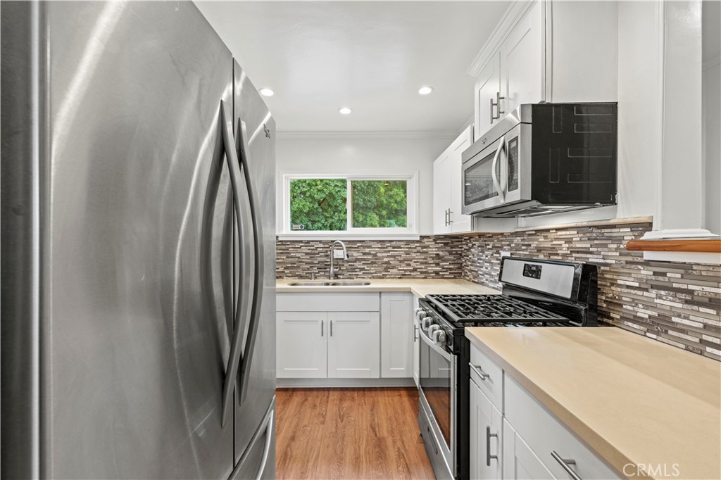 65 Grace Terrace Pasadena, CA 91105 - Photo 11 of 39 a kitchen with stainless steel appliances a refrigerator sink and stove