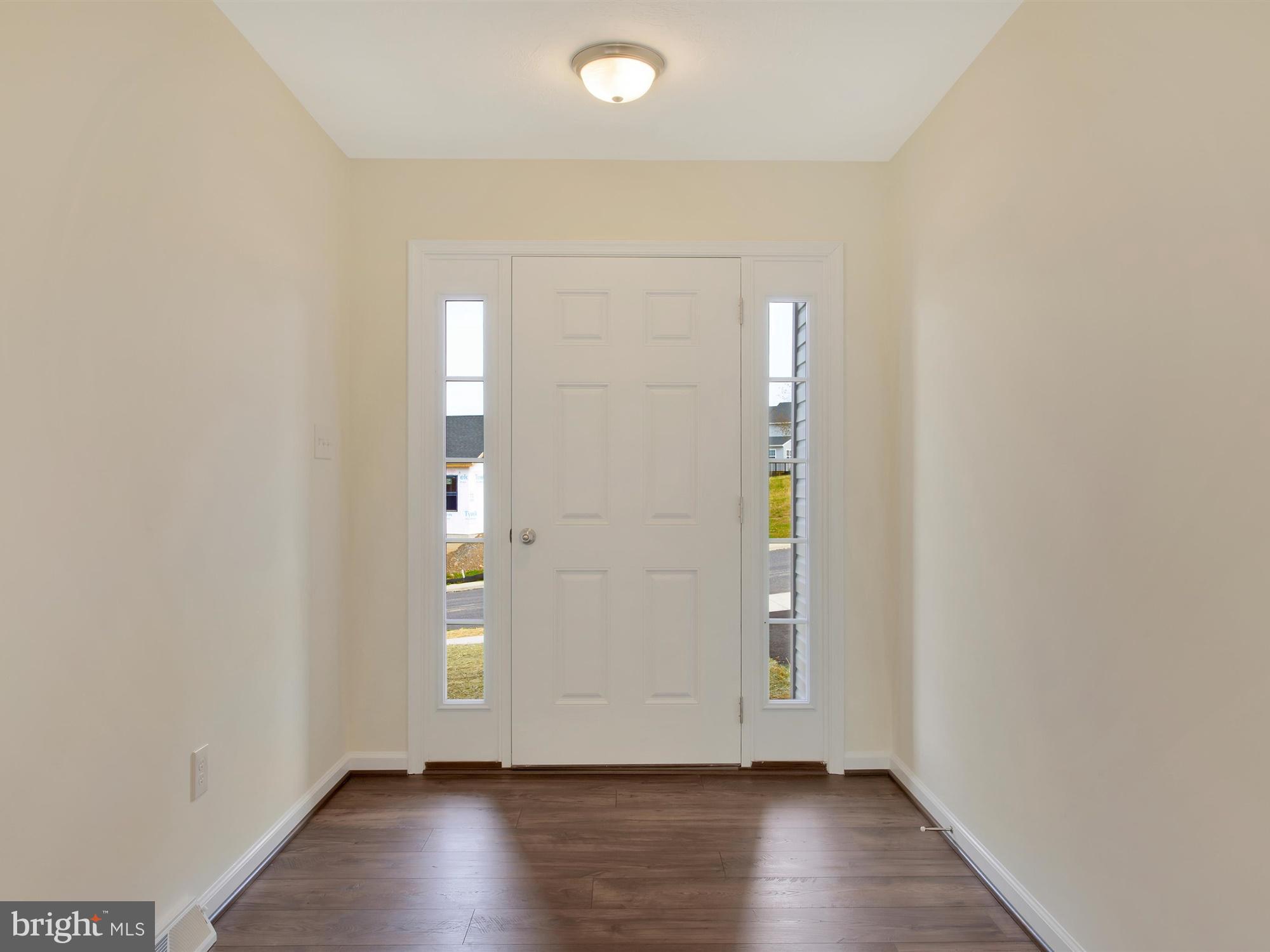47 Huntmaster Drive Hanover, PA 17331 - Photo 4 of 22 an empty room with wooden floor and windows