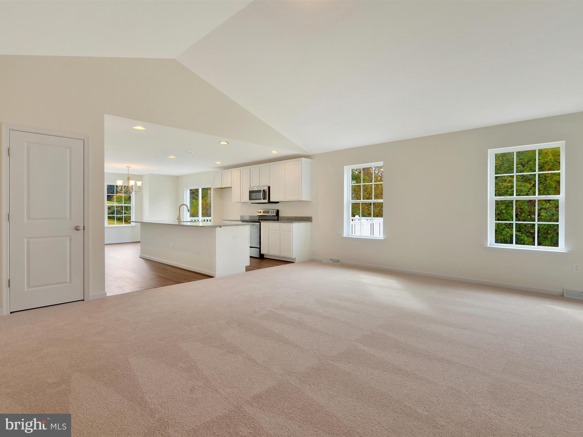 47 Huntmaster Drive Hanover, PA 17331 - Photo 6 of 22 a view of an empty room with a window and wooden floor