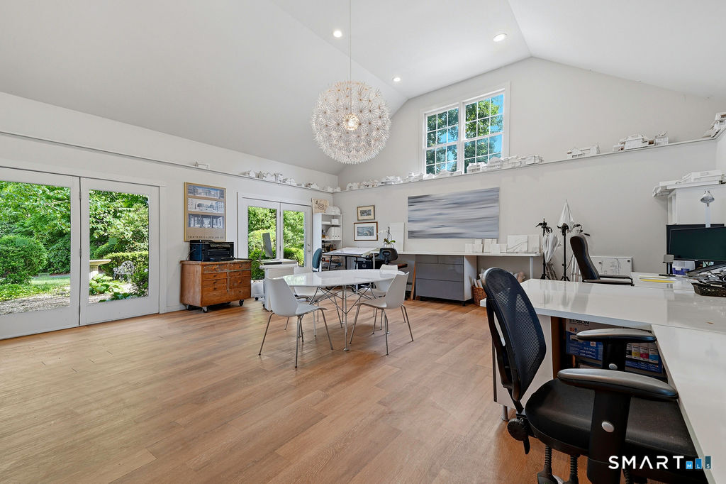261-1 Grassy Hill Road Lyme, CT 06371 - Photo 15 of 40 Spacious and seamlessly connected to a private courtyard, this versatile space offers a tranquil setting for work and relaxation.