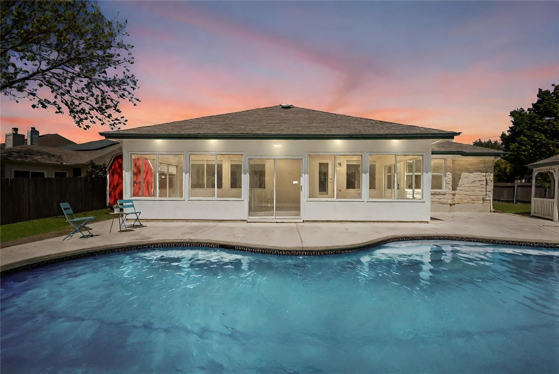 This 3045 sqft one story home comes with a glass enclosed sun room and pool!
