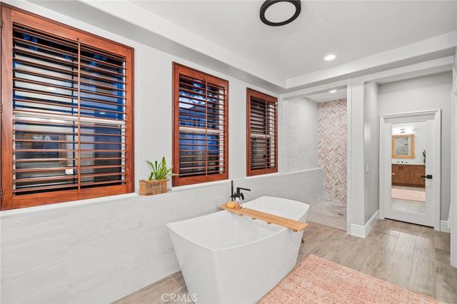 a view of an empty room with a fireplace and windows