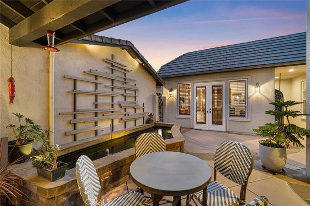 a balcony with furniture and a potted plant