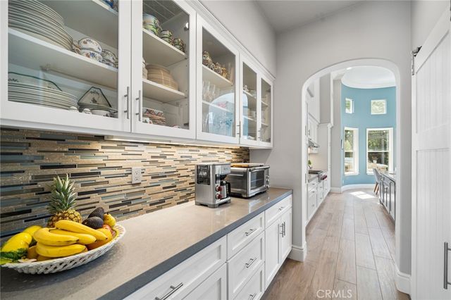 a kitchen with a sink and wooden floor