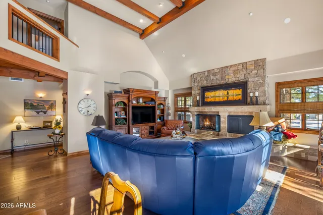 a living room with furniture a couch and large windows