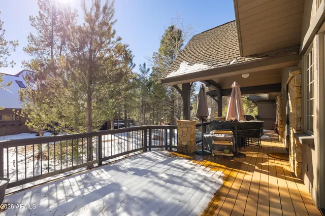 a view of patio with table and chairs and wooden floor