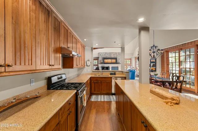 a kitchen with refrigerator a stove and a wooden cabinets