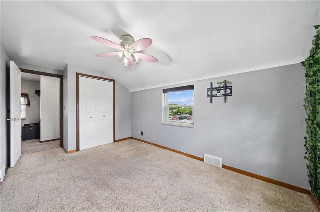 711 Jane Street Pittsburgh, PA 15239 - Photo 11 of 27 Spacious and well-lit, this second bedroom features cozy carpeting and a modern ceiling fan.