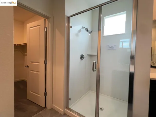 a bathroom with a glass shower door