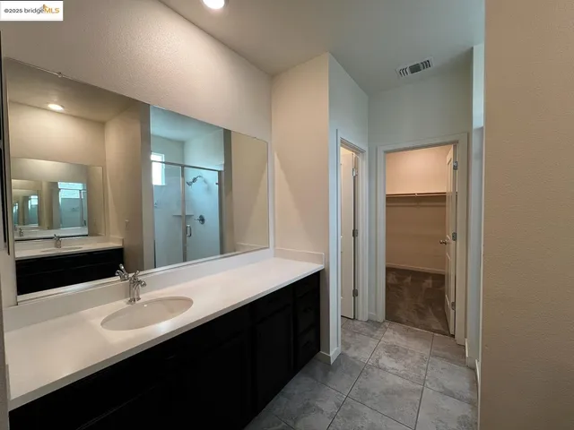 a bathroom with a double vanity sink a and a mirror