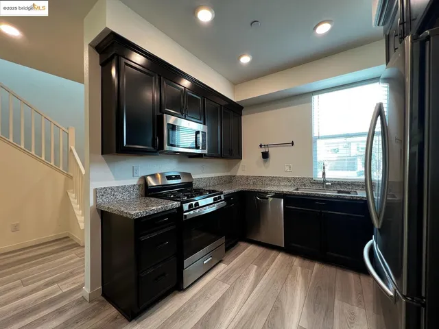a kitchen with stainless steel appliances granite countertop a stove and a sink