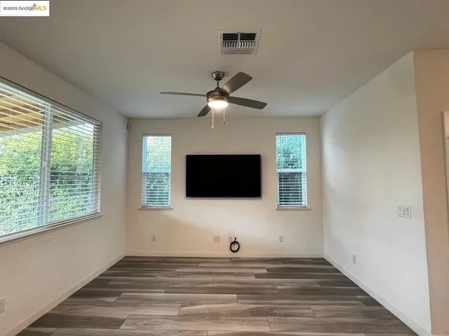 a living room with a flat screen tv and a window