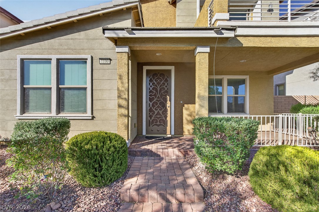 1100 East Sunset Road Henderson, NV 89011 - Photo 4 of 58 A welcoming brick paver walkway leads to a covered entry with an ornate front door.
