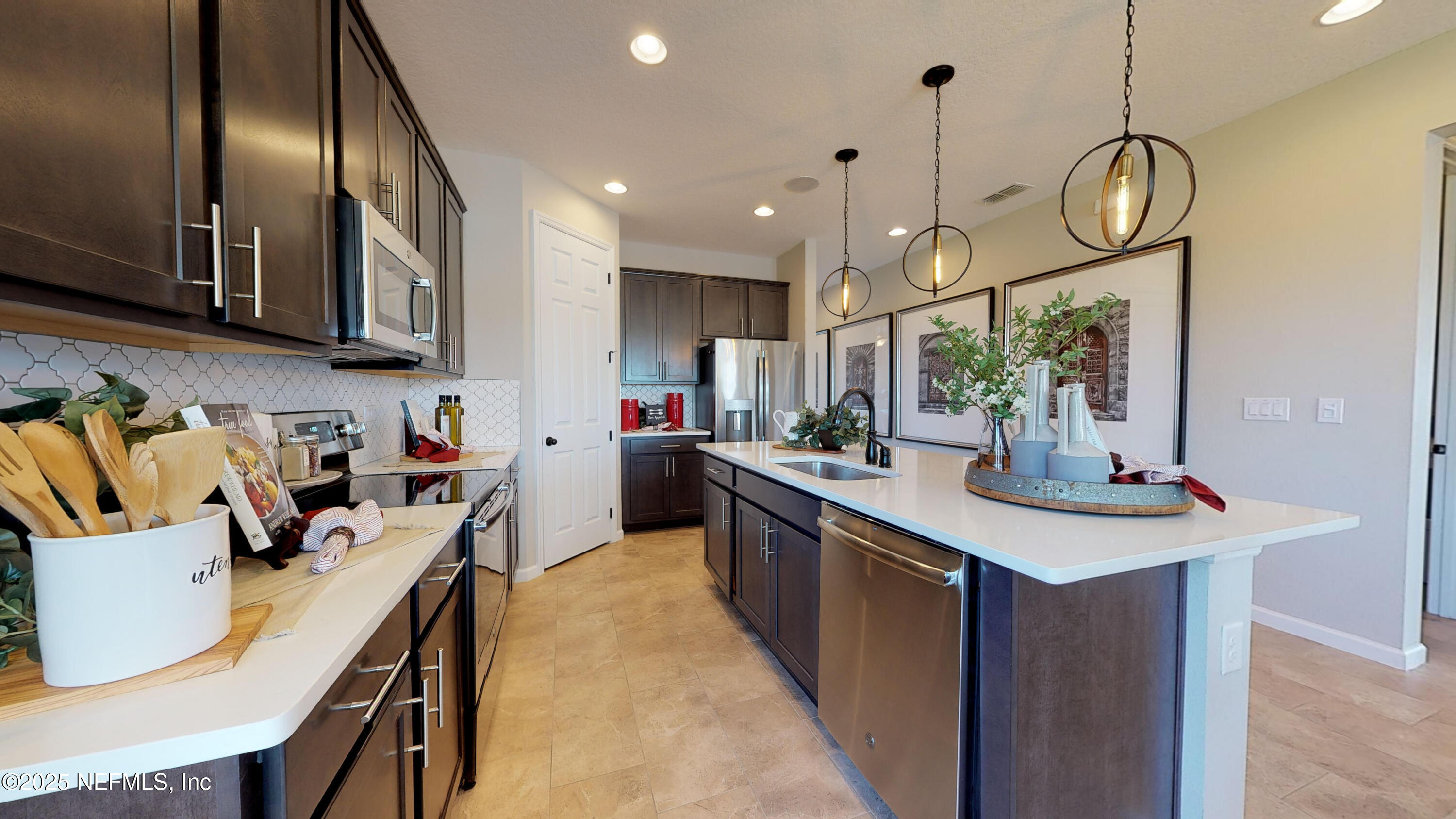 324 Alexandrite Street DeLand, FL 32720 - Photo 4 of 17 a kitchen with wooden cabinets and stainless steel appliances