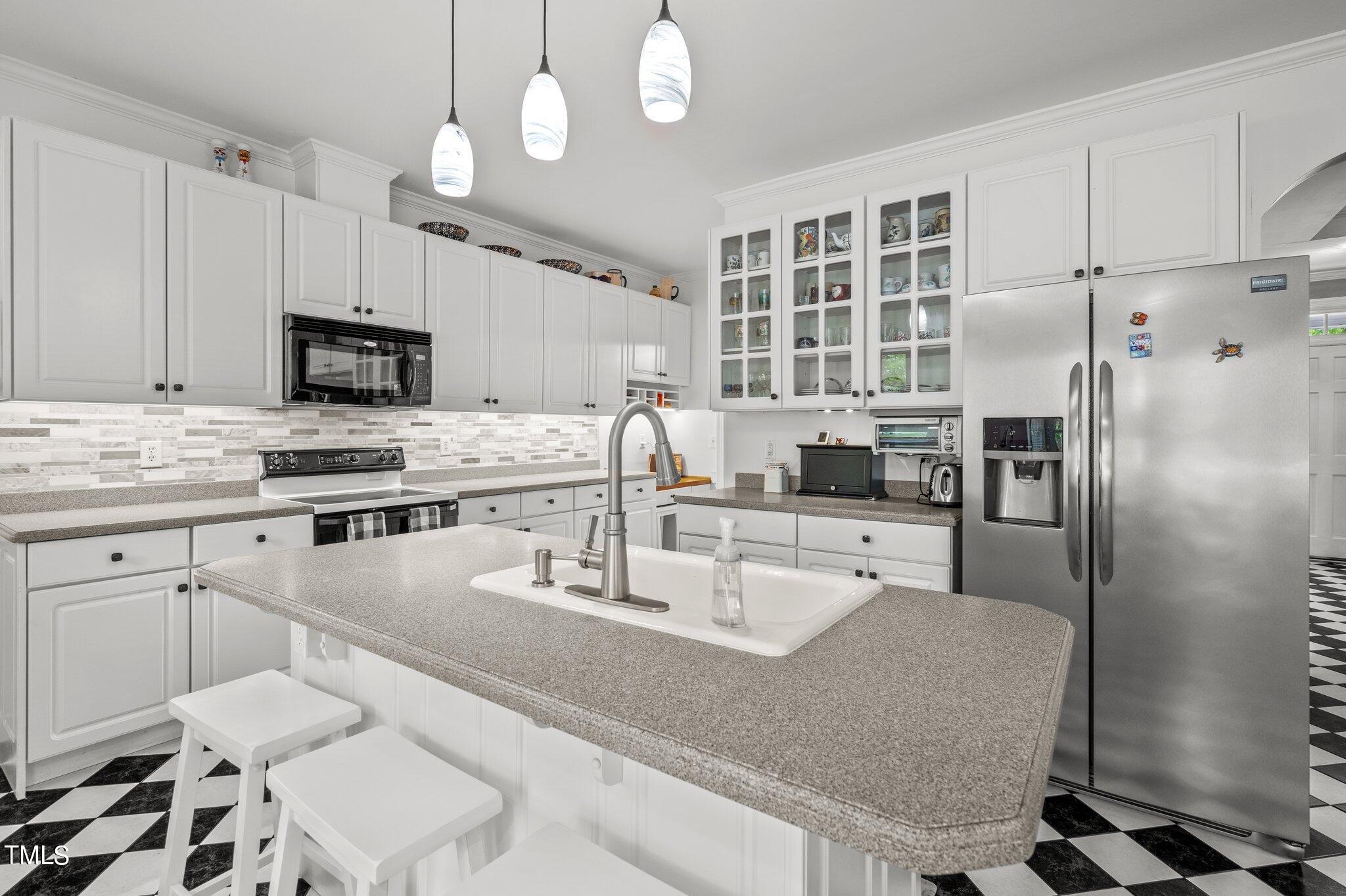 100 Shepton Drive Cary, NC 27519 - Photo 12 of 43 a kitchen with granite countertop a sink stainless steel appliances and cabinets