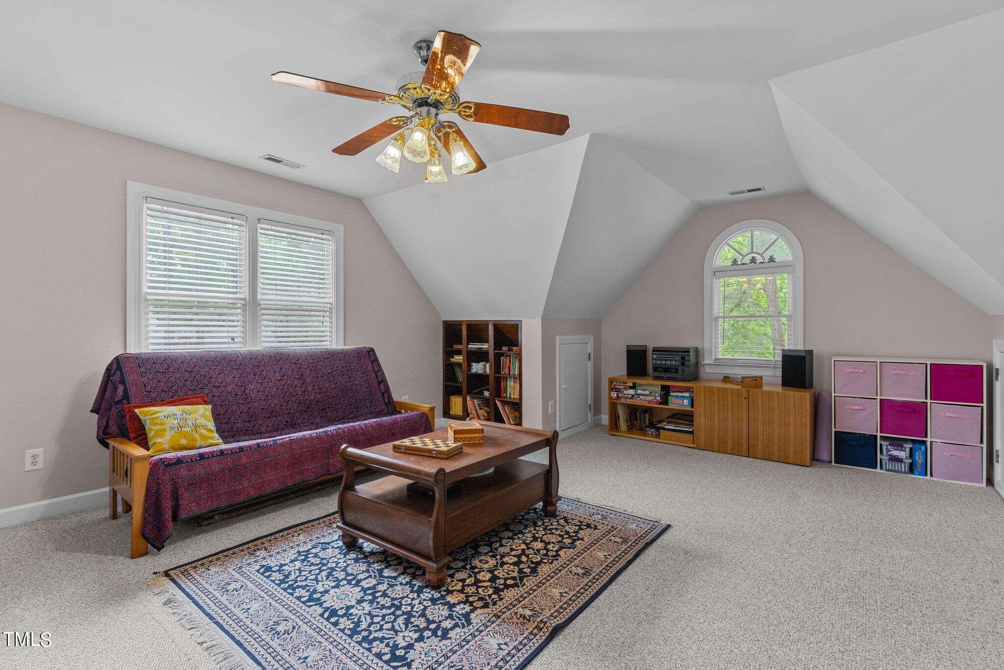 100 Shepton Drive Cary, NC 27519 - Photo 24 of 43 a living room with furniture and a chandelier