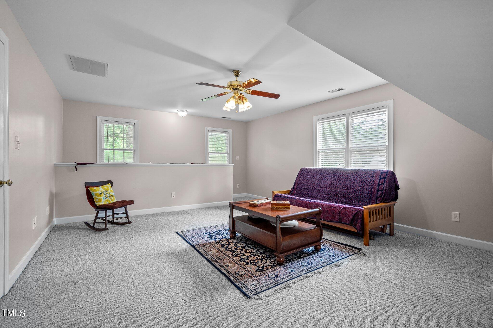 100 Shepton Drive Cary, NC 27519 - Photo 25 of 43 a living room with furniture a window and a chandelier