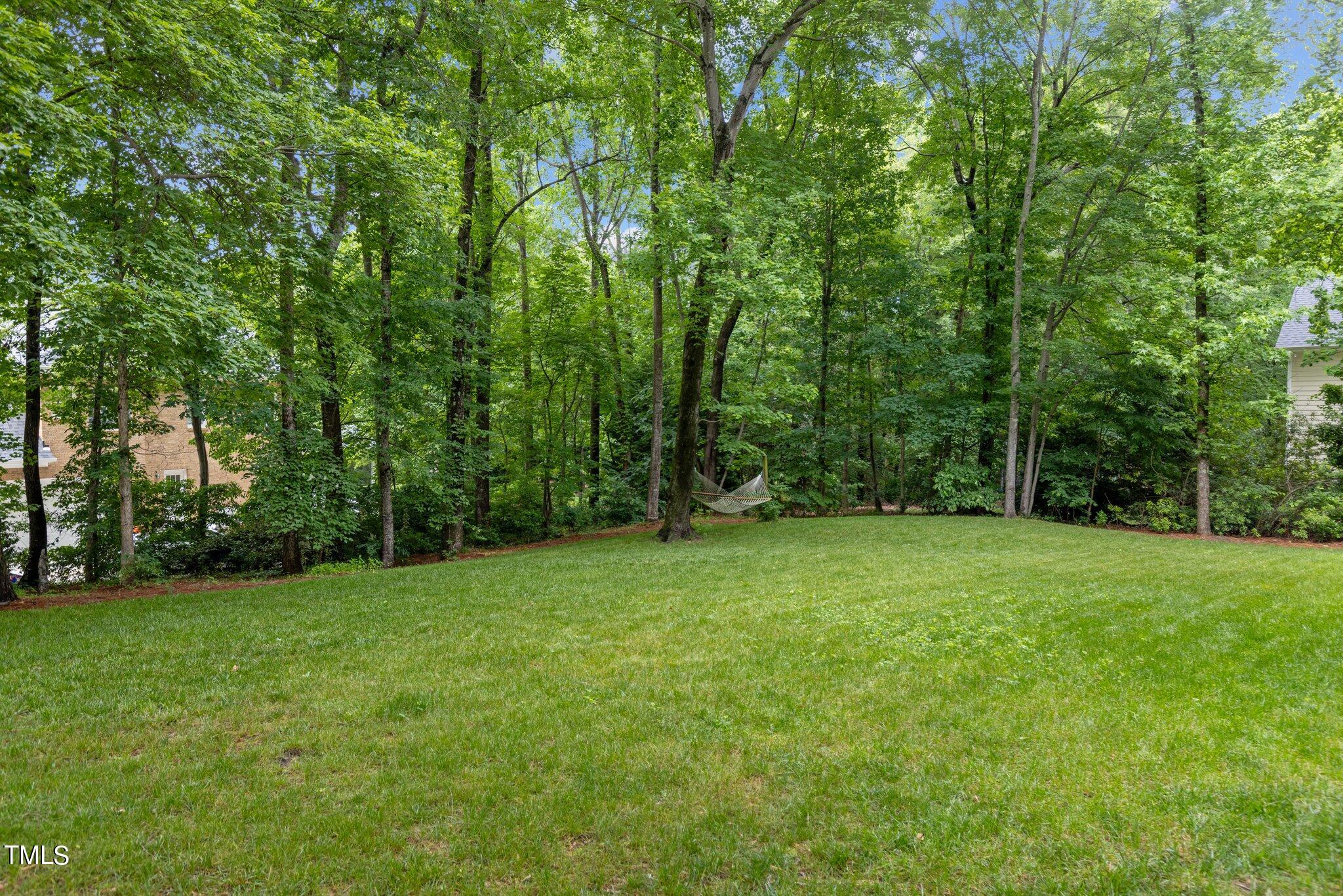 100 Shepton Drive Cary, NC 27519 - Photo 32 of 43 a view of a grassy field with trees in the background