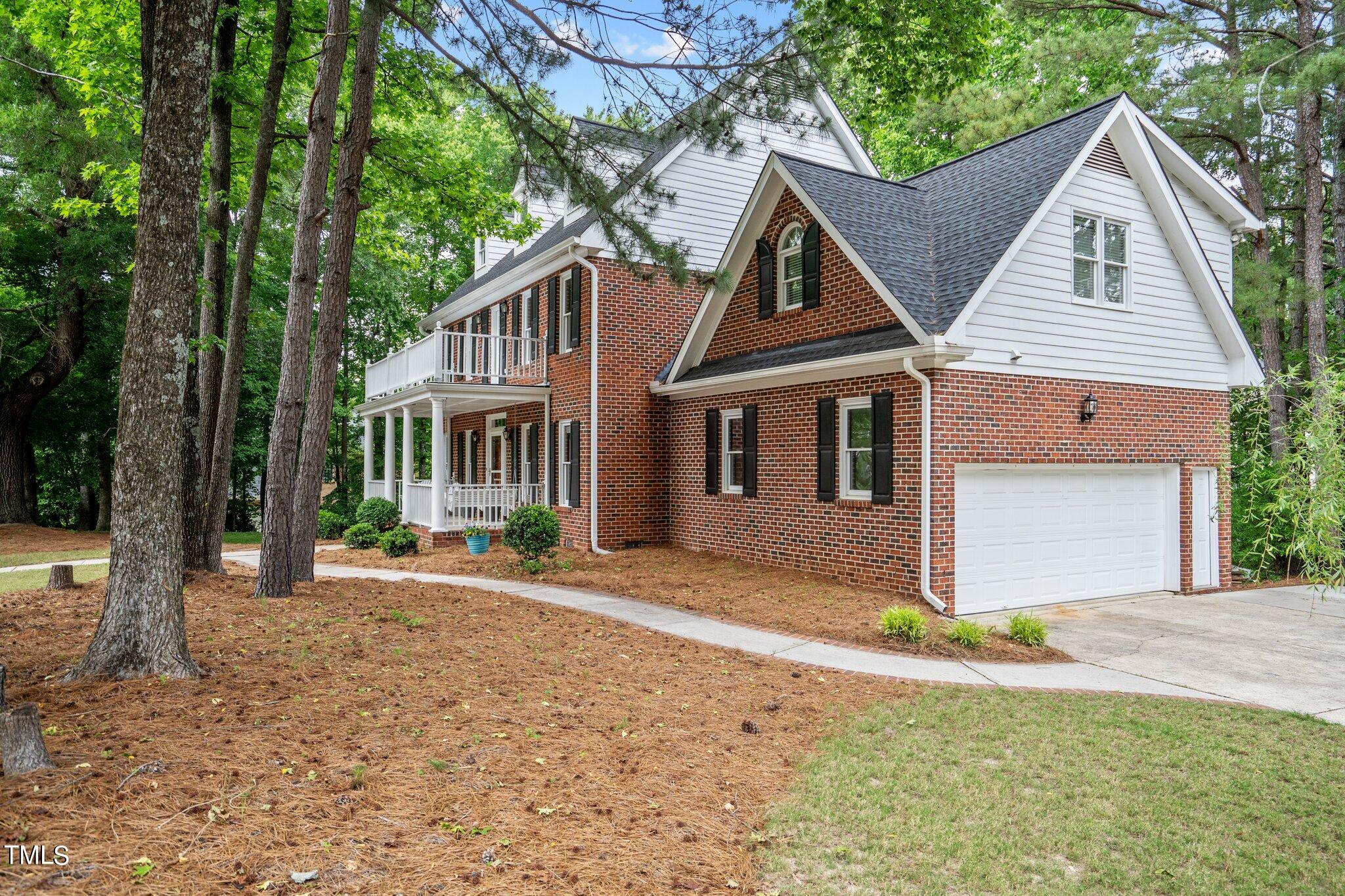 100 Shepton Drive Cary, NC 27519 - Photo 4 of 43 a front view of a house with a garden