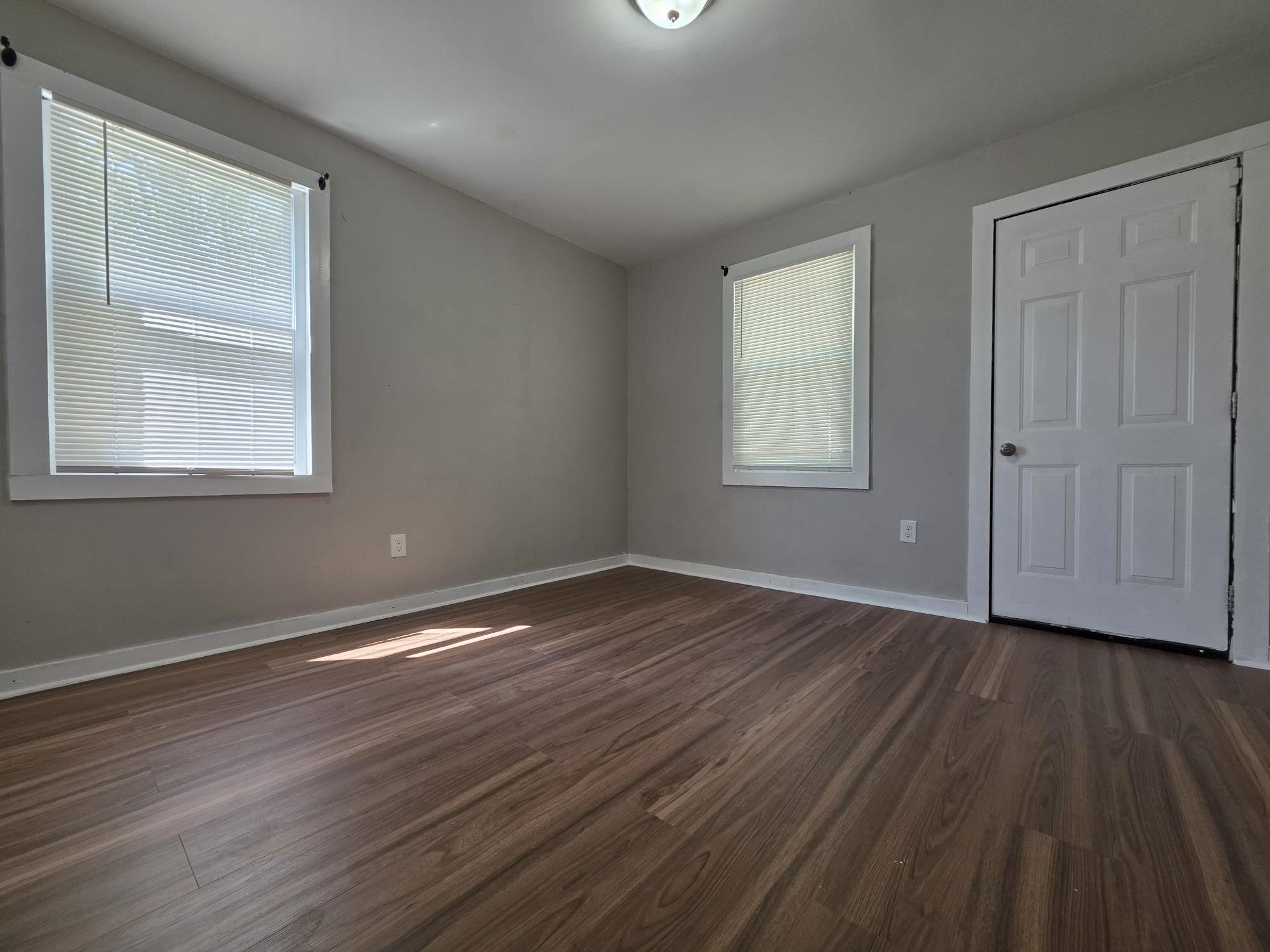 1319 Nicholas Street Memphis, TN 38107 - Photo 12 of 14 a view of an empty room with wooden floor and a window