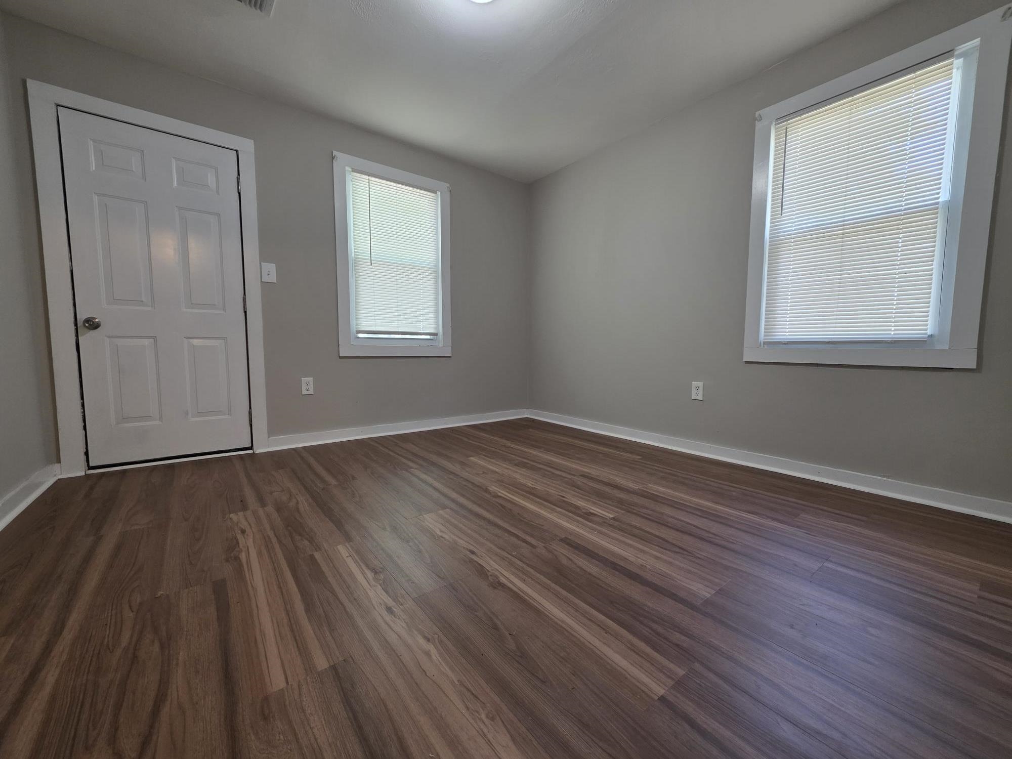 1319 Nicholas Street Memphis, TN 38107 - Photo 10 of 14 a view of an empty room with wooden floor and a window