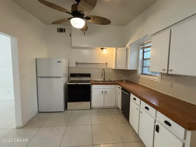 a kitchen with a sink cabinets and stainless steel appliances