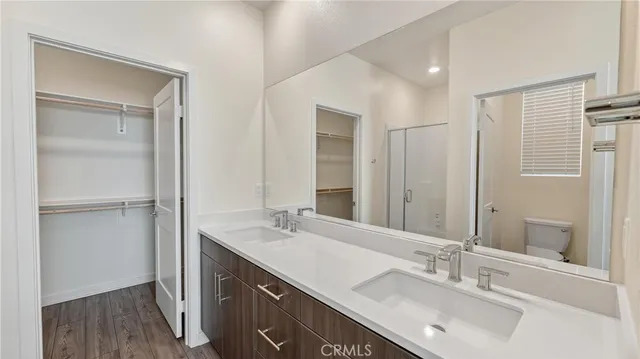 a bathroom with a sink double vanity and a mirror