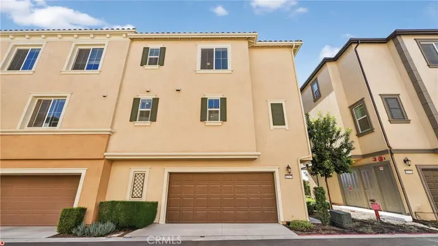 an aerial view of multiple houses with yard