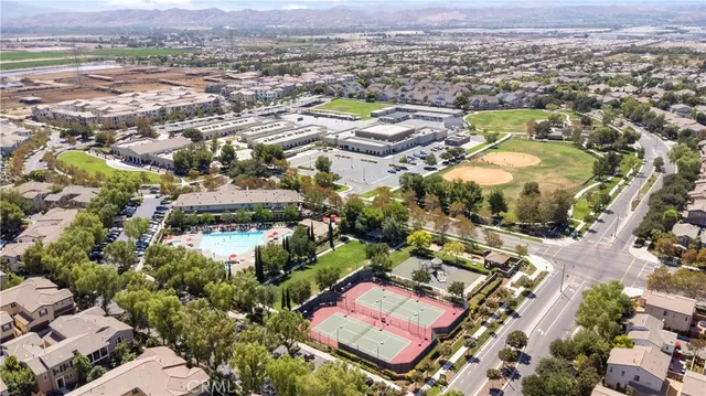 an aerial view of residential houses with outdoor space and street view