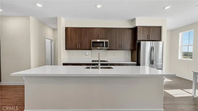 a view of a refrigerator in kitchen and wooden floor