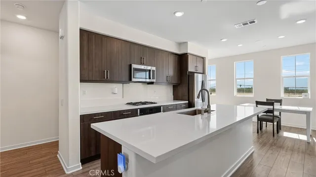 a kitchen with a stove a sink and a microwave