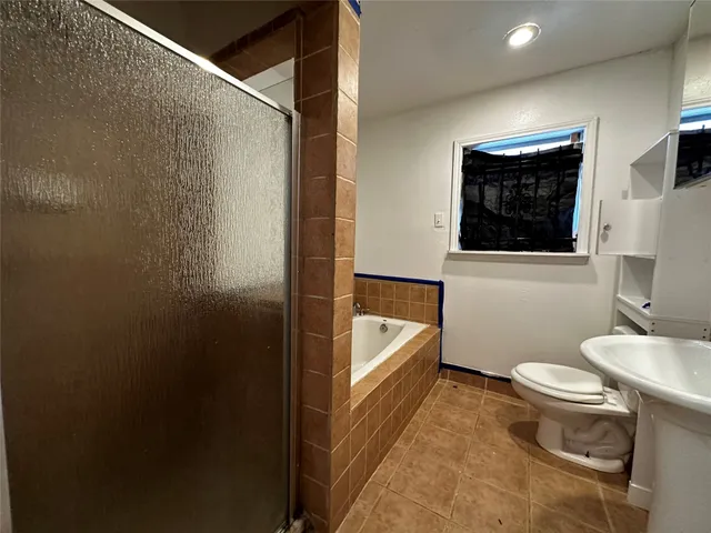 a bathroom with a sink a toilet a bathtub and mirror