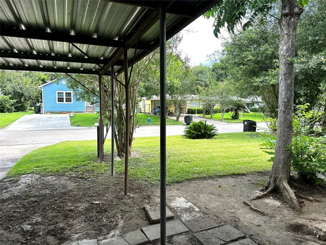 a view of a porch with furniture and a backyard