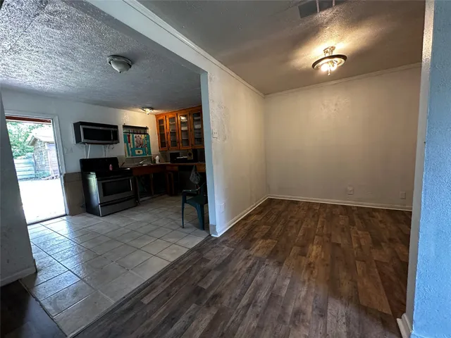 a view of a livingroom with furniture and an empty room