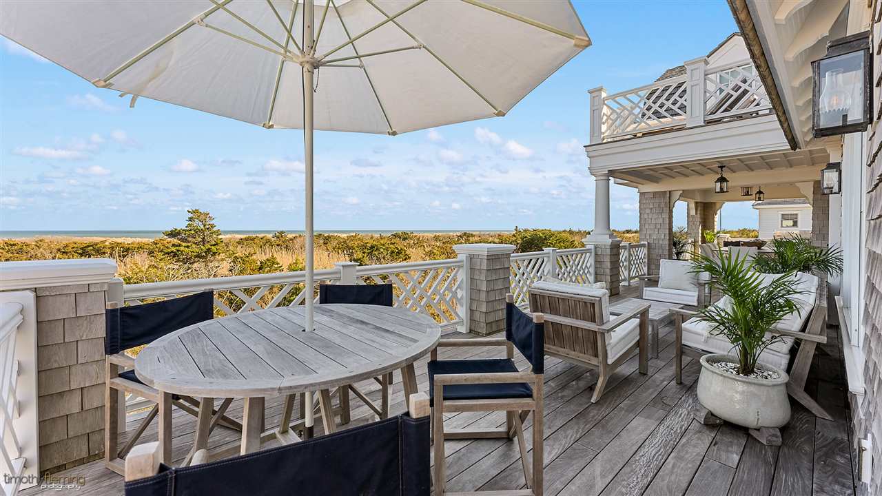 74 38th Street Avalon, NJ 08202 - Photo 22 of 39 a view of a chairs and table in the patio with a barbeque grill