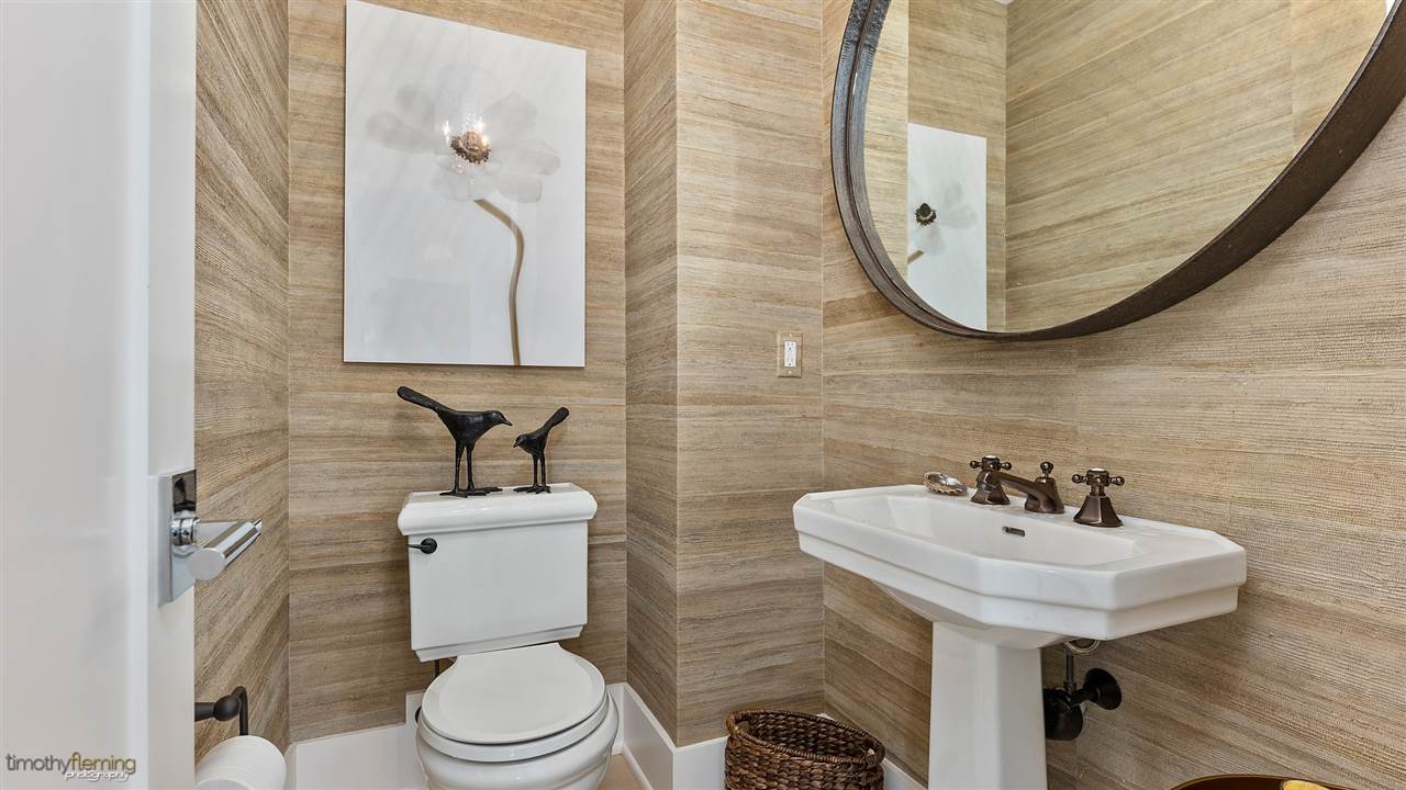 74 38th Street Avalon, NJ 08202 - Photo 24 of 39 a bathroom with a toilet sink and mirror