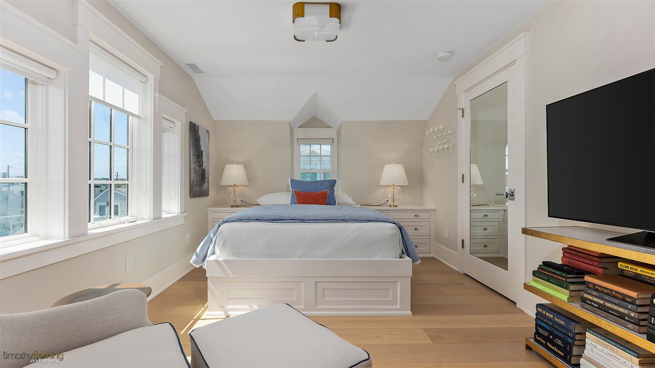 74 38th Street Avalon, NJ 08202 - Photo 26 of 39 a bedroom with a bed and a flat screen tv