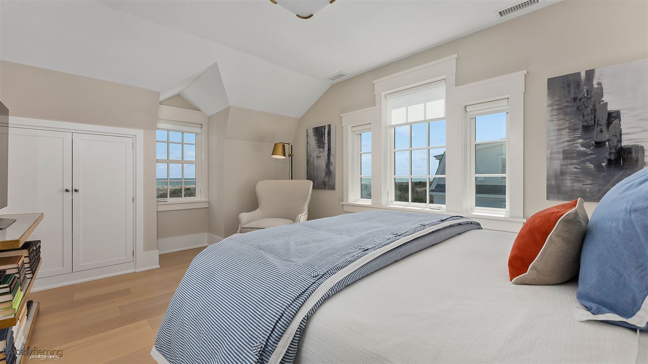74 38th Street Avalon, NJ 08202 - Photo 27 of 39 a spacious bedroom with a bed and glass door